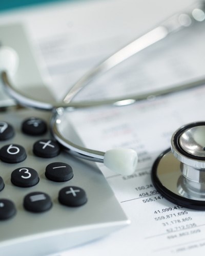 Calculator and stethoscope on financial statement concept for finance health check or cost of healthcare